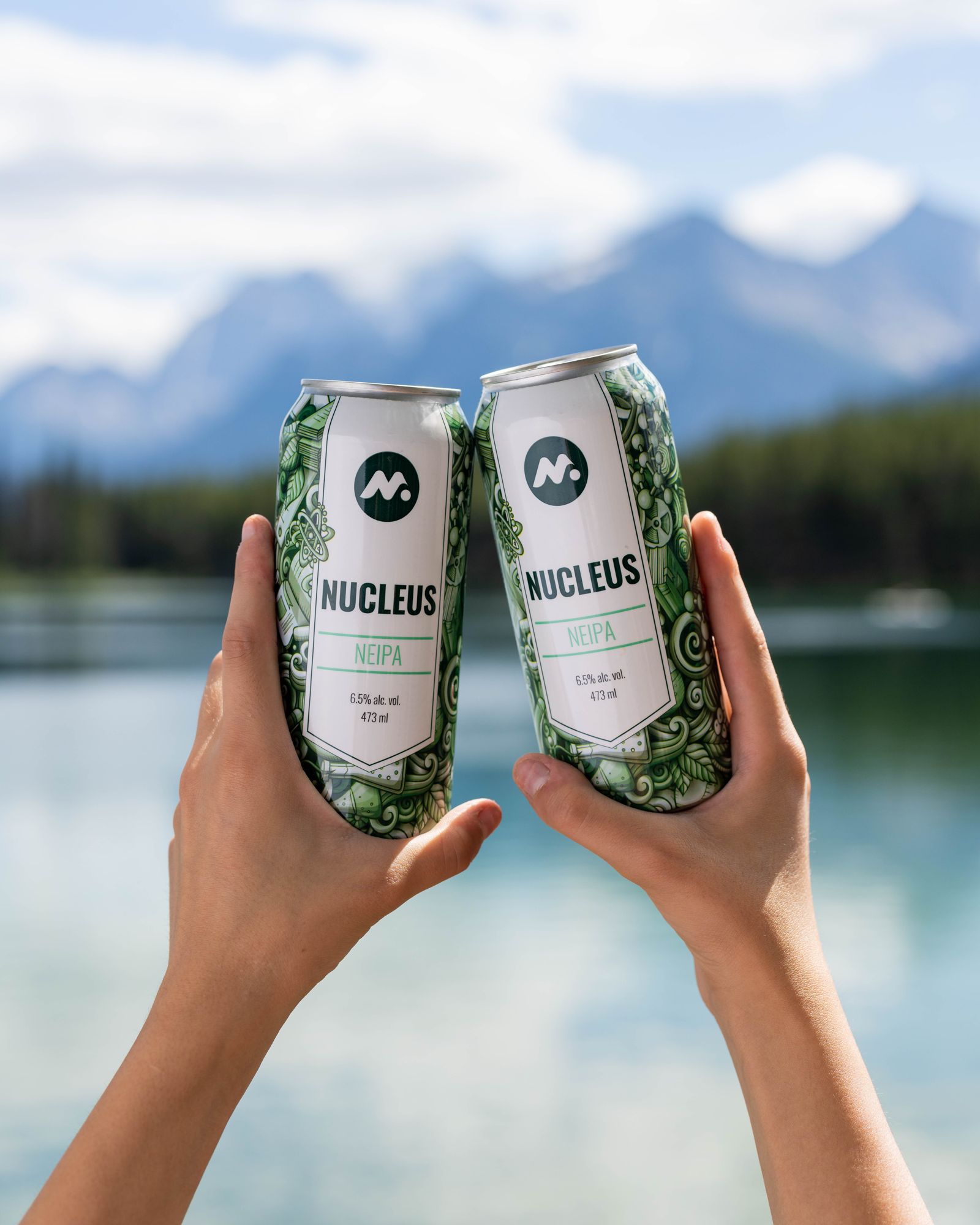Toasting with Meta beer over a mountain lake
